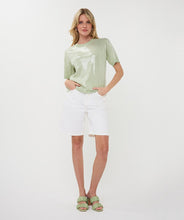 Load image into Gallery viewer, Woman wearing a light green sequin top, white shorts and light green sandals on a white background.