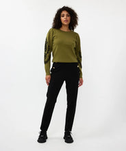 Load image into Gallery viewer, Our Sanne sweater is a work of art and a masterpiece of comfort and style. This olive-green sweater features elegant puff sleeves and intricate black stitching details. Crafted with anti-pilling acrylic, it promises durability and superior quality.