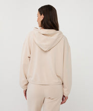 Load image into Gallery viewer, Woman wearing a beige hoodie top and matching pants against a white background.