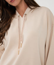 Load image into Gallery viewer, Woman wearing a beige hoodie with rose gold sequin drawstrings.