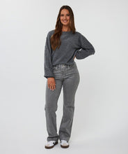 Load image into Gallery viewer, Woman wearing a grey sweater with grey pearls, jeans and white sneakers against a white background.