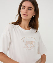 Load image into Gallery viewer, Woman wearing an off-white t-shirt with animal print against a white background.