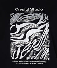 Load image into Gallery viewer, Close-up of graphic print- zebra pattern with sequins and text "Crystal Studio Est. 1985 Avenue Montaigne Champs-Elysees Paris Festive Inspiration in the streets "on a black background.