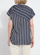 Load image into Gallery viewer, The Tamar Stripe Bow-Tie Neck Top is a standout piece, designed in a nautical collage color with distinctive stripes for a timeless, chic appeal. Made from premium Lightweight Satin, this top offers a luxurious feel while maintaining effortless wearability. Its relaxed, boxy fit is complemented by stylish details like a bow tied to one shoulder and a rounded, high-low shirttail hem. Perfect for casual yet polished ensembles, the Tamar Stripe Bow-Tie Neck Top is a versatile addition.