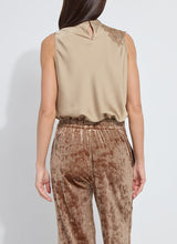 Load image into Gallery viewer, Woman wearing a beige sleeveless top with lace detail and brown velvet pants against a white background.