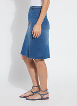 Load image into Gallery viewer, Crafted from 4-way stretch Knit Denim, the Tess Braided Denim Pencil Skirt boasts a knee-length design and boasts a patented waistband, sand blasting, and patch pockets. With princess seaming, a left-front vent, and hand braided details at the waist, this skirt is a true standout!