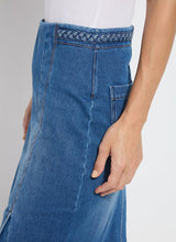 Load image into Gallery viewer, Crafted from 4-way stretch Knit Denim, the Tess Braided Denim Pencil Skirt boasts a knee-length design and boasts a patented waistband, sand blasting, and patch pockets. With princess seaming, a left-front vent, and hand braided details at the waist, this skirt is a true standout!