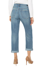Load image into Gallery viewer, Model wearing white long top, light blue cuffed jeans and beige heels against a white background.