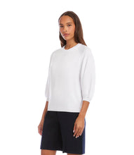 Load image into Gallery viewer, Woman wearing a white sweater and navy shorts on a white background.