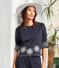 Load image into Gallery viewer, Add a touch of timeless elegance to your wardrobe with the Tesni Three Quarter Sleeve Embroidered Scallop Top by Karen Kane. Featuring delicate floral embroidery, a scalloped hem, and chic puff sleeves, this sophisticated blouse offers a graceful yet modern look for any occasion. Perfect for brunch, workdays, or an evening out, this lightweight embroidered top pairs effortlessly with jeans, skirts, or tailored pants.