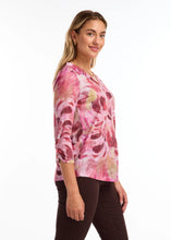 Load image into Gallery viewer, This top showcases a striking abstract pattern in vibrant pink shades and is crafted from luxuriously smooth fabric, making it a versatile piece that easily complements any ensemble for a modern aesthetic.