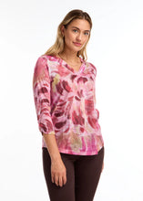 Load image into Gallery viewer, This top showcases a striking abstract pattern in vibrant pink shades and is crafted from luxuriously smooth fabric, making it a versatile piece that easily complements any ensemble for a modern aesthetic.