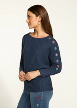 Load image into Gallery viewer, The Nessie Navy Batwing Top from FDJ French Dressing showcases intricate and vibrant floral details along the outer edge of the sleeves, adding an appealing and unique touch to any ensemble. The loose-fitting batwing design ensures a comfortable and stylish look, suitable for any occasion.