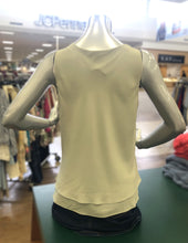 Load image into Gallery viewer, Mannequin wearing a light-colored green sleeveless top against a blurred store background.