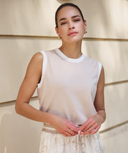 Load image into Gallery viewer, Woman wearing a sand-colored sleeveless top with off white contrast and safari patterned pants against a neutral wall.