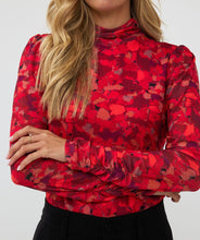 Load image into Gallery viewer, Who says winter has to be drab? Enhance your winter wardrobe with a touch of color. This stunning top features a vibrant multi color design that pairs well with denim or black pants. Wear it solo or layer it under a black blazer for a sophisticated look.