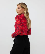 Load image into Gallery viewer, Who says winter has to be drab? Enhance your winter wardrobe with a touch of color. This stunning top features a vibrant multi color design that pairs well with denim or black pants. Wear it solo or layer it under a black blazer for a sophisticated look.