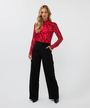 Load image into Gallery viewer, Who says winter has to be drab? Enhance your winter wardrobe with a touch of color. This stunning top features a vibrant multi color design that pairs well with denim or black pants. Wear it solo or layer it under a black blazer for a sophisticated look.