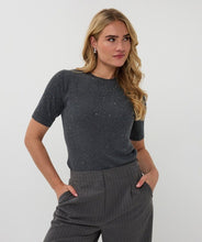 Load image into Gallery viewer, Woman wearing a dark gray sequin ribbed short-sleeve top and gray pinstripe pants against a white background.