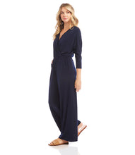 Load image into Gallery viewer, Our best-selling jumpsuit is now available in a beautiful navy color! Crafted from a high-quality, wrinkle-resistant jersey fabric, this jumpsuit is as low-maintenance as it is chic. Designed for the modern jetsetter, this jumpsuit combines comfort, style, and practicality for a seamless travel experience.