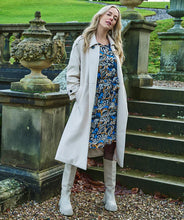 Load image into Gallery viewer, Classic, chic, and timeless, this stunning EsQualo Trenchcoat in a beautiful bisquit color is a must-have. The chic long trench coat features a bow belt and beautiful button details on the hem, sleeves, and shoulders, making it a perfect blend of elegance and sophistication.