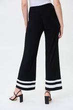 Load image into Gallery viewer, A gorgeous pant that will take you from day to evening, our Tatum trim detail pant in a striking black and white contrast, essentially pairs perfectly with so many of your favorite solid tops. A flared cut and contrast white trim create an eye-catching design that is not only fashionable but also flattering. Colors - Black and vanilla. Pull-on style. Elastic waist. No pockets.