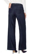 Load image into Gallery viewer, Model wearing dark blue denim trouser, blue heels and white top against a white background.