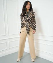 Load image into Gallery viewer, Constructed with cargo pockets and a trendy wide leg fit, these Tanner Trousers from EsQualo offer both comfort and style. The tan (sand) color complements most tops and the elastic waistband ensures a comfortable fit. Perfect for any fashion-forward wardrobe.