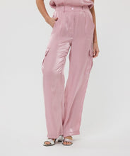 Load image into Gallery viewer, Slide into summer with these effortlessly chic silky cargos by EsQualo. Crafted in a soft pastel pink, they blend utility and elegance with a lightweight, flowy silhouette. Featuring an elastic waistband, side patch pockets, and a breezy wide-leg cut, these trousers are perfect for sunny strolls, weekend getaways, or dressing up with a strappy heel.