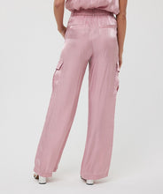 Load image into Gallery viewer, Slide into summer with these effortlessly chic silky cargos by EsQualo. Crafted in a soft pastel pink, they blend utility and elegance with a lightweight, flowy silhouette. Featuring an elastic waistband, side patch pockets, and a breezy wide-leg cut, these trousers are perfect for sunny strolls, weekend getaways, or dressing up with a strappy heel.