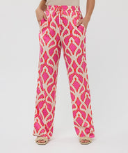 Load image into Gallery viewer, The EsQualo Taimi Trousers Disco Spark are a bold and stylish statement piece designed for effortless elegance. Featuring a vibrant pink-orange disco spark print, these trousers bring energy and sophistication to any outfit. Pair with a fitted top for a sleek contrast or a matching blouse for a coordinated ensemble.