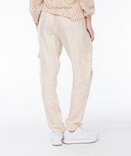 Load image into Gallery viewer, Experience ultimate comfort with our light sand colored cargo pants featuring an elastic waist band. The fabric is cool to the touch, ensuring a comfortable and stylish look. Dress up with wedges or heels or create a casual vibe with a pair of sneakers. You will absolutely love the feel of these Tana trousers.