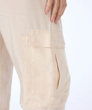 Load image into Gallery viewer, Experience ultimate comfort with our light sand colored cargo pants featuring an elastic waist band. The fabric is cool to the touch, ensuring a comfortable and stylish look. Dress up with wedges or heels or create a casual vibe with a pair of sneakers. You will absolutely love the feel of these Tana trousers.