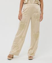 Load image into Gallery viewer, From brunch to cocktail hour, these shimmer-ready trousers are made to shine. The Sherica Sequin Trousers in Champagne feature a flattering high-rise elastic waistband, straight-leg cut, and allover micro-sequin embellishment for a dose of confidence and glam. Fully lined for comfortable wear, they’re ideal for dressing up—or dressing boldly.