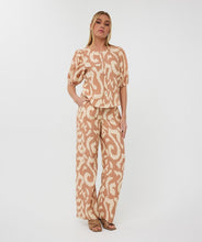 Load image into Gallery viewer, The EsQualo Trousers Solar Swing are stylish and comfortable pants featuring an all-over print design, wide legs, and side pockets for functionality. They come with two welt pockets at the back and an elastic waistband with a drawstring, accented with gold beading for a chic touch. A perfect pant for warm days, the Toma offers a lightweight and breathable fit.