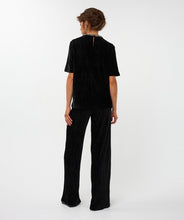 Load image into Gallery viewer, Model wearing a black outfit on a white background.