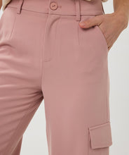 Load image into Gallery viewer, These trousers bring a perfect blend of style and functionality with their wide-leg cargo design. Tailored for versatility, they feature a relaxed yet chic fit, making them ideal for both casual days and elevated occasions. The charming chalk pink color adds a soft, feminine touch, while the high-quality fabric ensures lasting comfort and durability. With practical cargo-style pockets, these trousers strike the perfect balance between utility and fashion.