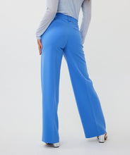 Load image into Gallery viewer, These beautiful electric blue wide leg trousers are adorned with clean pleated seams on the front and back, giving off a sophisticated and refined appearance. The elastic waistband allows for a comfortable and flattering fit. Suitable for both casual and formal events, these trousers make a versatile wardrobe addition.