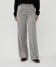 Load image into Gallery viewer, Woman wearing a black sweater, gray pants and black shoes against a white background.
