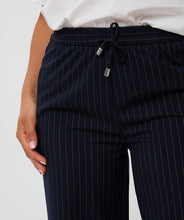 Load image into Gallery viewer, Close-up of navy pinstripe pants with drawstrings against a white background.