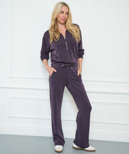 Load image into Gallery viewer, The EsQualo W2405714 Trine Trousers boast a luxurious satin finish and soft, breathable modal fabrication. The dark purple hue adds a touch of elegance, making them versatile for both casual and dressy occasions. With convenient satin pockets, zipper pockets, and a shimmering lurex drawstring, these trousers are both functional and stylish.