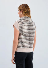 Load image into Gallery viewer, Woman wearing a black and ivory patterned vest over a turtleneck and black pants against a plain background.