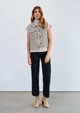 Load image into Gallery viewer, Woman wearing a black and ivory patterned vest over a turtleneck, black pants and tan boots against a plain background.
