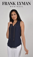Load image into Gallery viewer, The Frank Lyman Style 221025 top features a beautiful dark navy color, aptly named Twilight. It also includes a detachable necklace adorned with gold, navy and gold beads, as well as a fringe of twilight navy. The neckline and bottom of the top feature delicate ruffle details, adding an extra touch of intrigue. A versatile and stylish choice for any occasion.