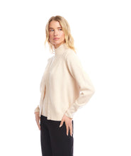 Load image into Gallery viewer, Woman wearing a coordinating beige turtleneck top and cardigan and black pants against a white background.