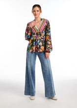 Load image into Gallery viewer, Experience the retro vibe with the ultra-comfortable Olivia jean from FDJ French Dressing, showcasing a wide trouser leg with pintuck stitching and a broad stitched hem. This stylish and contemporary jean features slanted front pockets and dual back pockets, crafted in a soft medium wash denim for a flattering look.