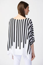 Load image into Gallery viewer, The charm of this breezy poncho top lies in its vibrant abstract print. Crafted from airy georgette, it showcases a boat neckline and generous dolman sleeves. This distinctive top is lined and includes a silky knit camisole beneath for added comfort. Color- Vanilla, pink and black. Georgette poncho with silky knit camisole. Boat neckline. Three-quarter dolman sleeves. Lined.
