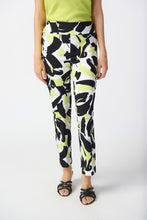 Load image into Gallery viewer, Introducing the Amaya Abstract Print Millennium Pull-On Pants by Joseph Ribkoff. Designed with a structured contour waistband and a stylish JR ornament, these cropped pants offer sophistication and comfort. Crafted from high-quality fabric, they provide both luxury and fun. Elevate your wardrobe with these bold and stylish pants. Color - Vanilla Multi - Key lime, black and vanilla. Millennium fabric. Structured contoured waistband. JR ornament detail. Unlined.