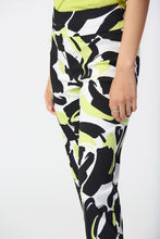 Load image into Gallery viewer, Introducing the Amaya Abstract Print Millennium Pull-On Pants by Joseph Ribkoff. Designed with a structured contour waistband and a stylish JR ornament, these cropped pants offer sophistication and comfort. Crafted from high-quality fabric, they provide both luxury and fun. Elevate your wardrobe with these bold and stylish pants. Color - Vanilla Multi - Key lime, black and vanilla. Millennium fabric. Structured contoured waistband. JR ornament detail. Unlined.