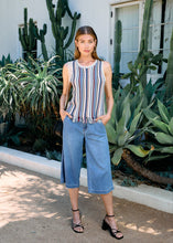 Load image into Gallery viewer, Stay effortlessly chic with this sleeveless cami sweater, featuring timeless vertical stripes and playful fringe accents. Perfect for warm days, it combines a breezy style with a touch of sophistication. Crafted from a soft blend of cotton, acrylic, and nylon, it offers comfort and durability. Pair it with your favorite bottoms for a versatile and stylish look!